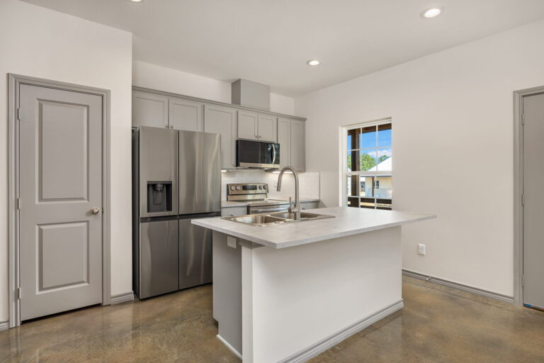 kitchen with gray cabinets, appliances and island