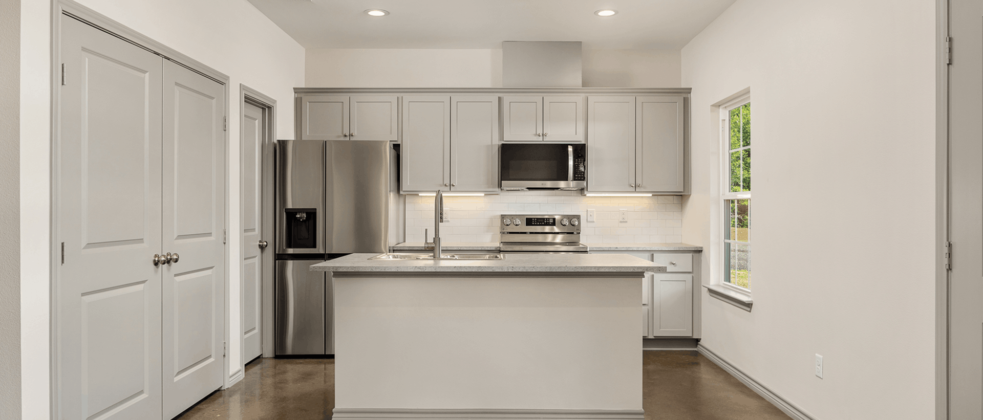 kitchen with gray cabinets and stainless steel appliances