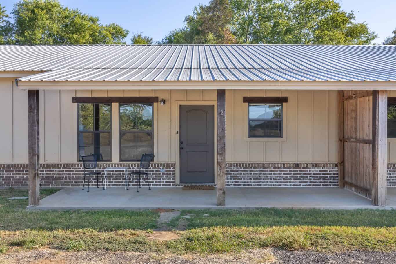outside porch featuring door and patio table