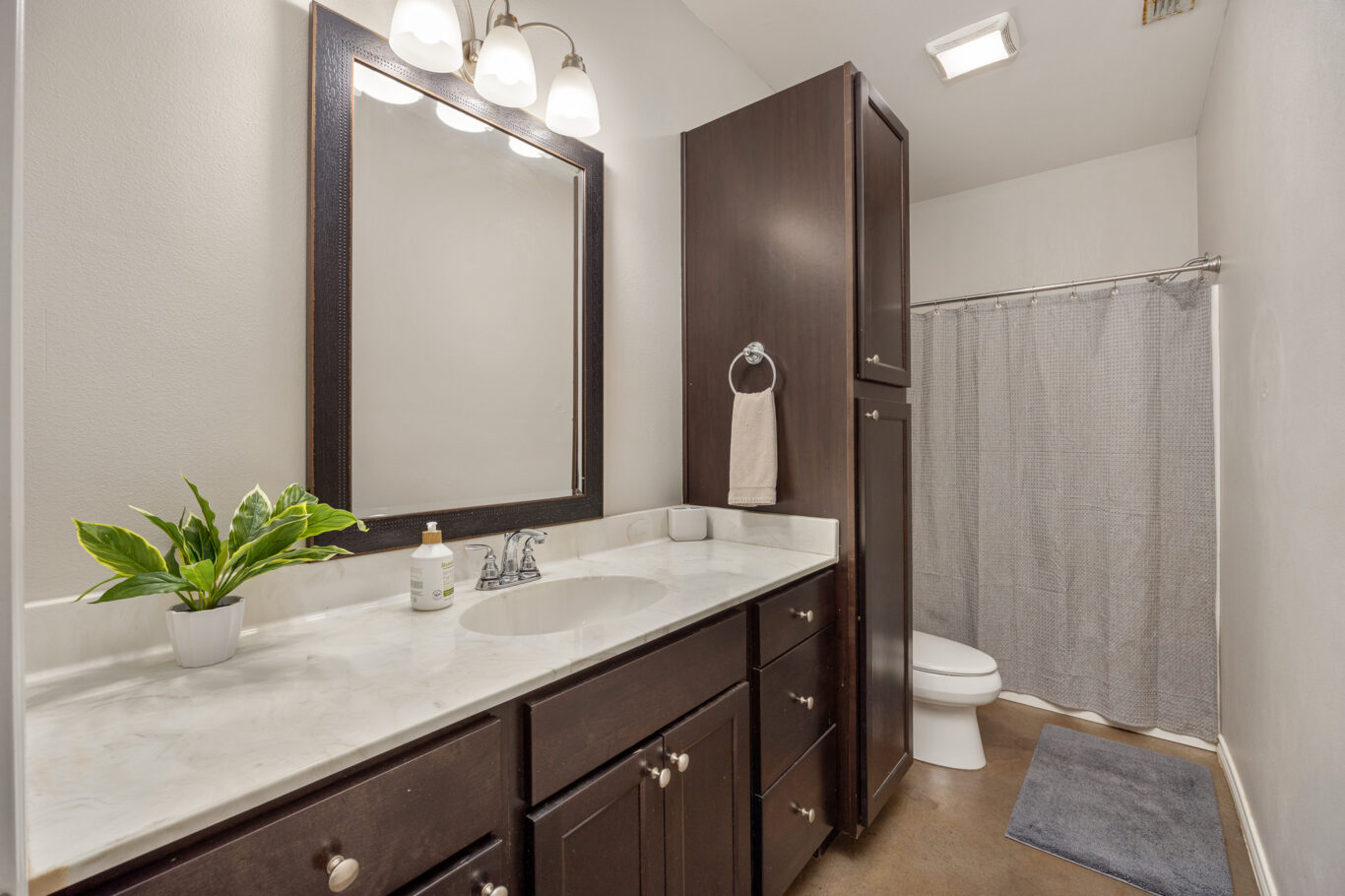 bathroom with linen cabinet and vanity