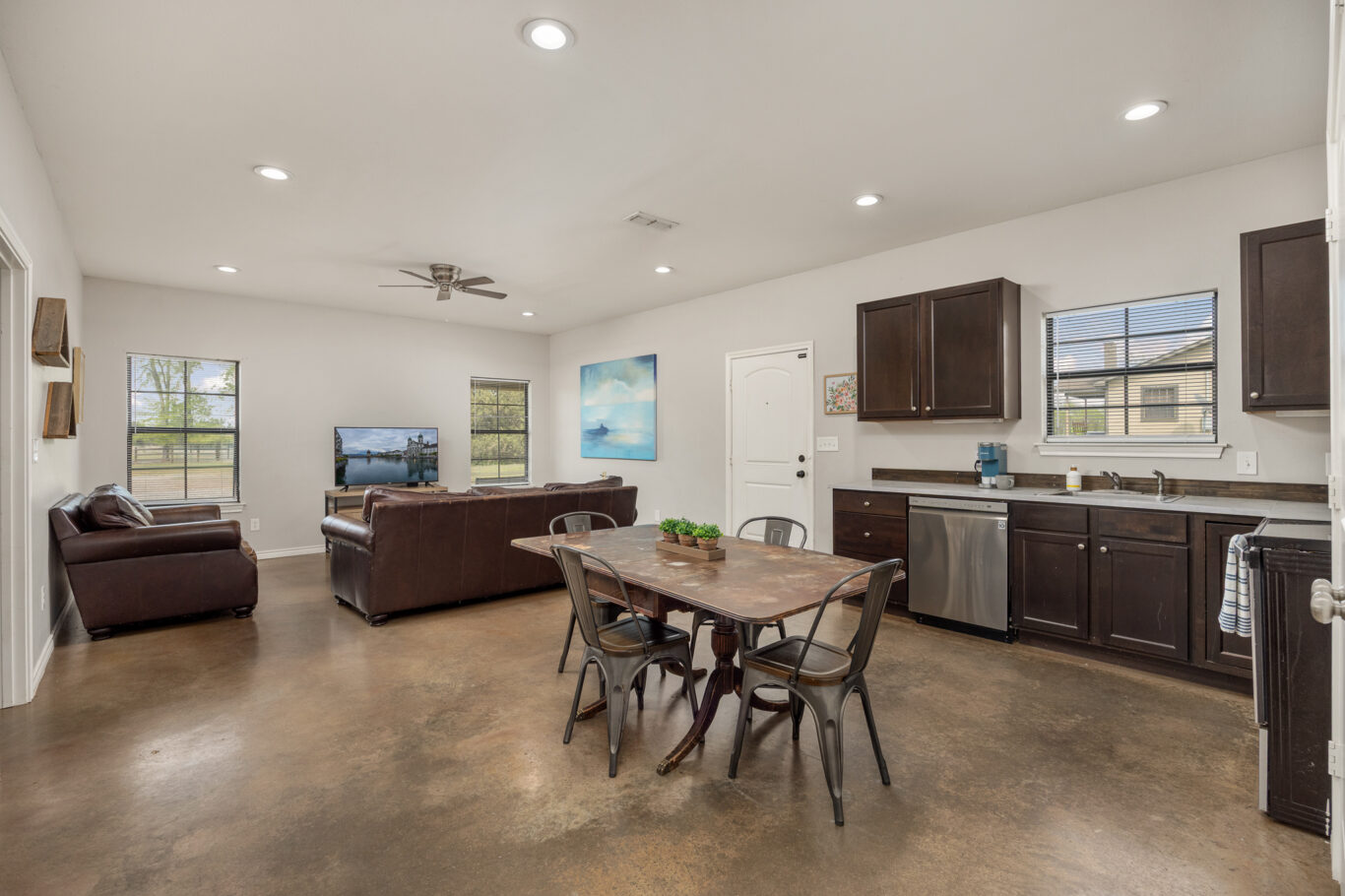furnished living room and kitchen with table
